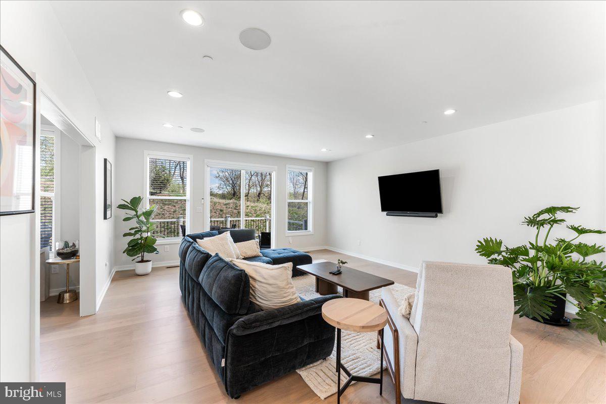 722 Switchman Road Media, PA 19063 - Photo 11 of 46 a living room with furniture a flat screen tv and a large window