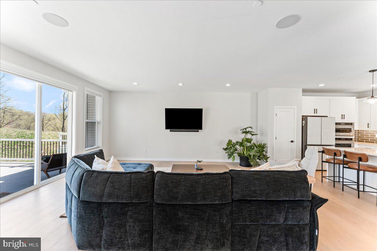722 Switchman Road Media, PA 19063 - Photo 12 of 46 a living room with furniture a flat screen tv and a large window