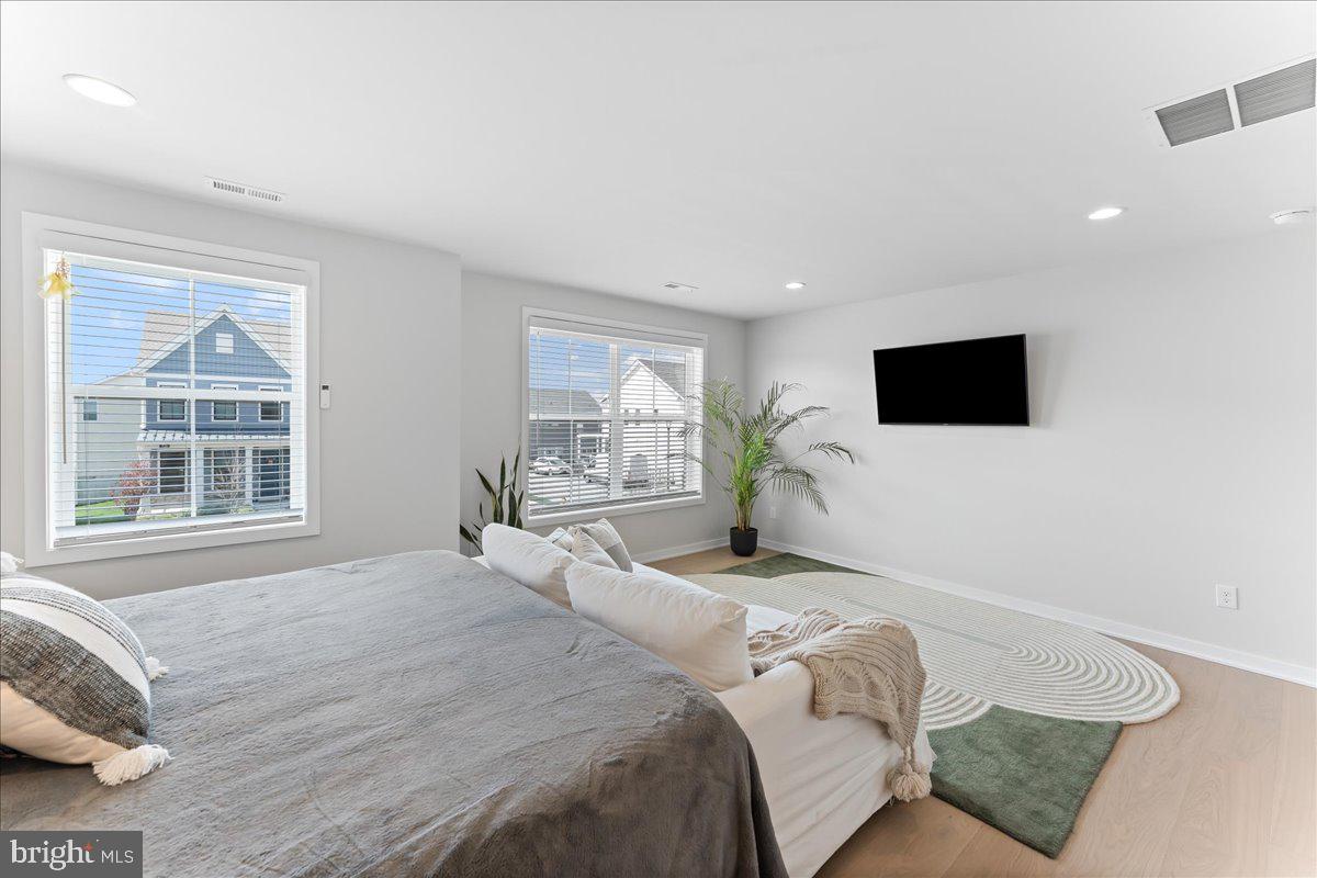 722 Switchman Road Media, PA 19063 - Photo 22 of 46 a spacious bedroom with a bed and a flat screen tv