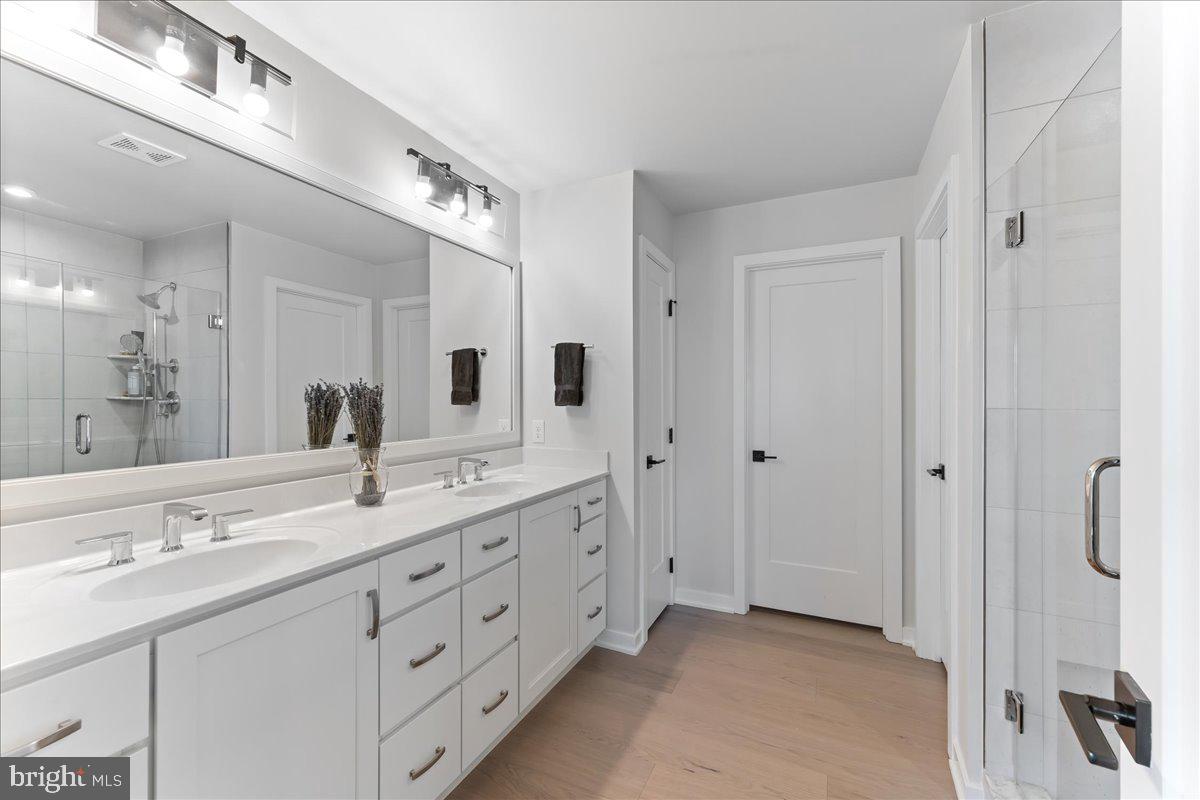 722 Switchman Road Media, PA 19063 - Photo 23 of 46 a bathroom with a double vanity sink and mirror