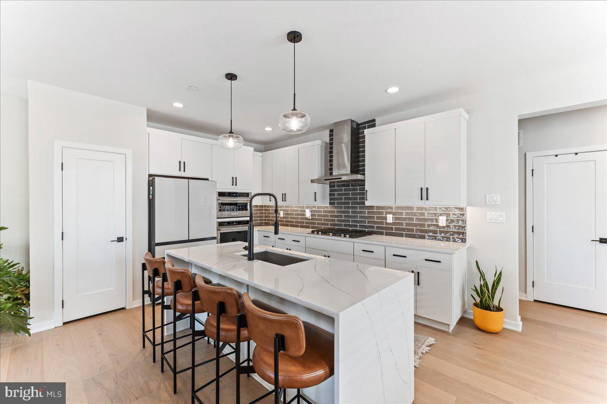 722 Switchman Road Media, PA 19063 - Photo 3 of 46 a kitchen with stainless steel appliances a dining table chairs stove and refrigerator