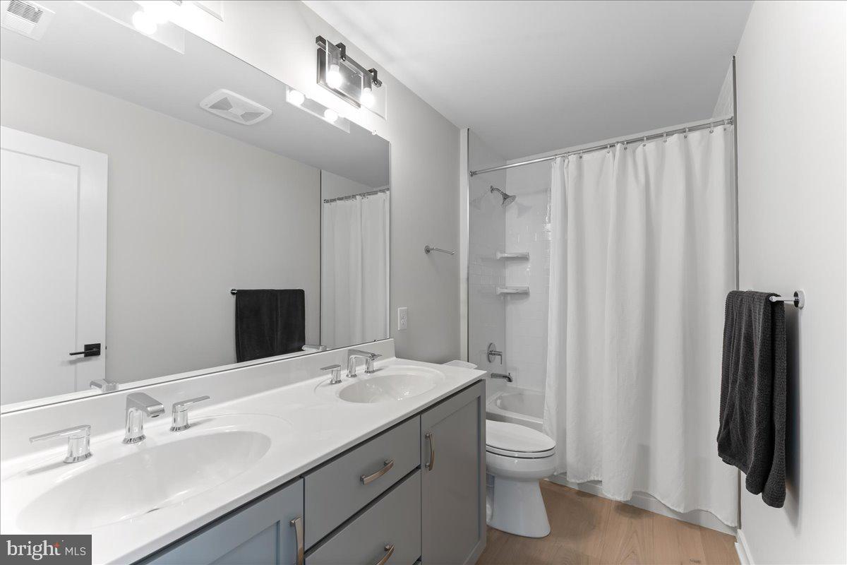 722 Switchman Road Media, PA 19063 - Photo 31 of 46 a bathroom with a double vanity sink and a mirror