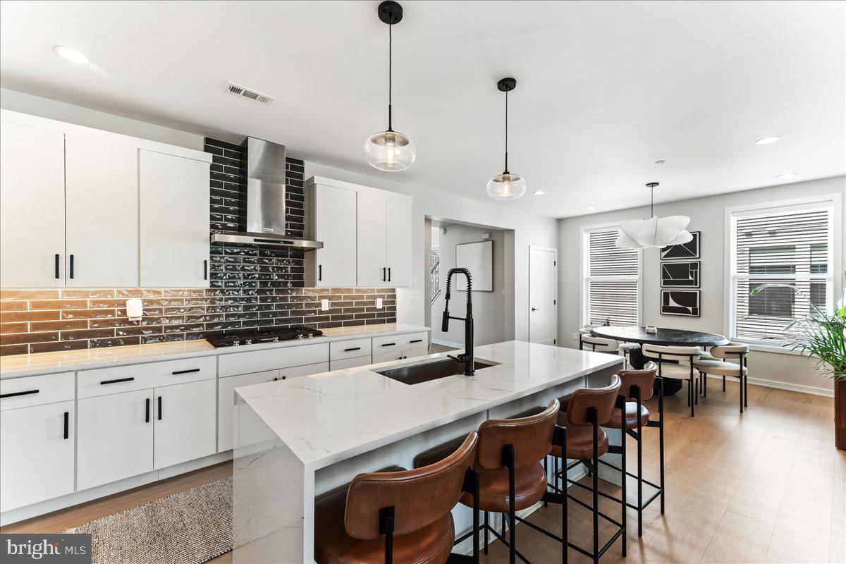 722 Switchman Road Media, PA 19063 - Photo 4 of 46 a kitchen with stainless steel appliances granite countertop a stove a sink a oven a dining table and chairs