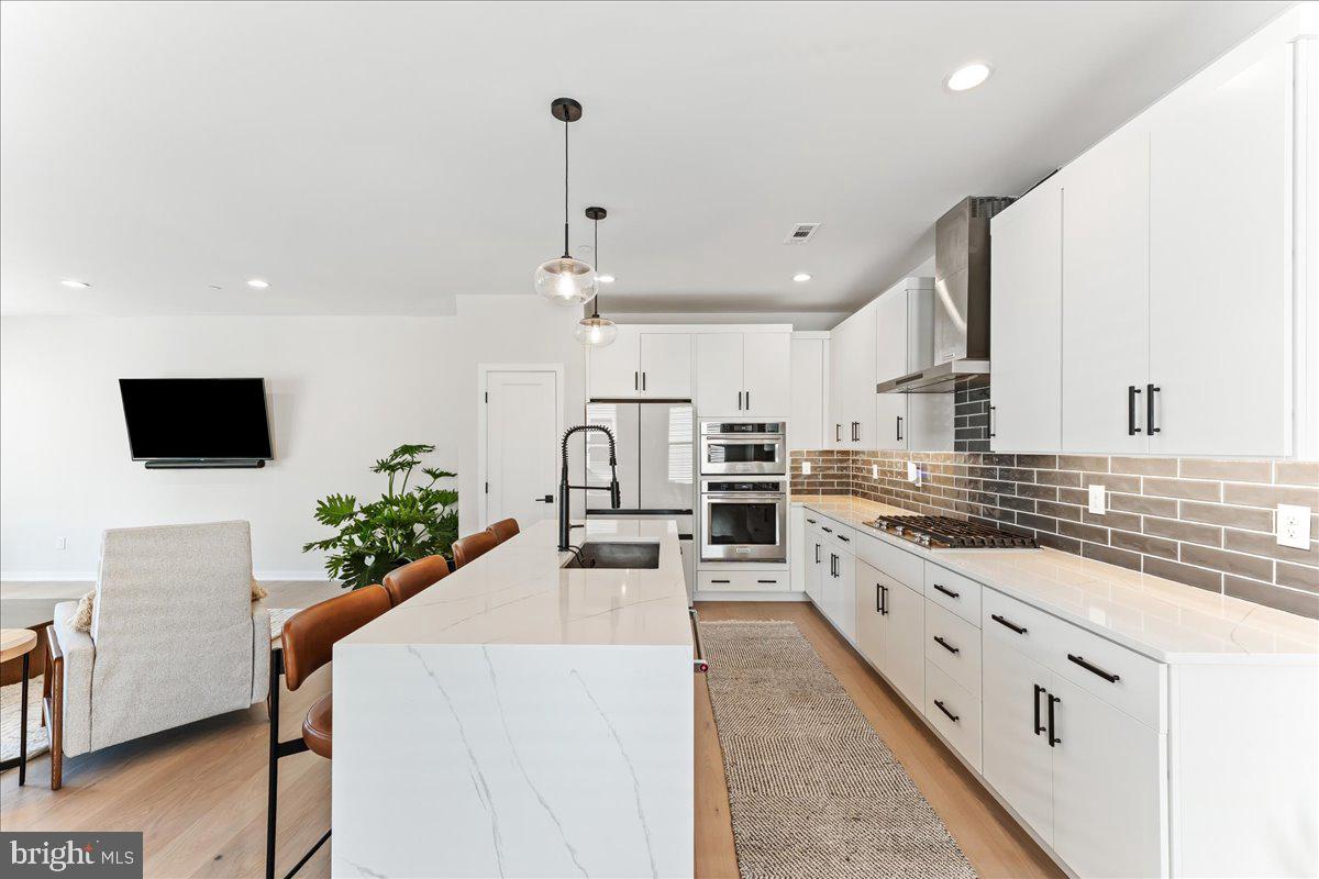 722 Switchman Road Media, PA 19063 - Photo 6 of 46 a large kitchen with stainless steel appliances kitchen island granite countertop a stove and a sink