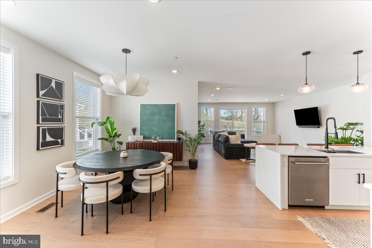 722 Switchman Road Media, PA 19063 - Photo 7 of 46 a kitchen with a table chairs refrigerator and microwave