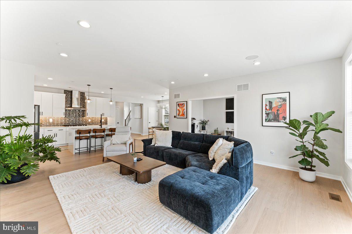 722 Switchman Road Media, PA 19063 - Photo 9 of 46 a living room with furniture potted plant and kitchen view