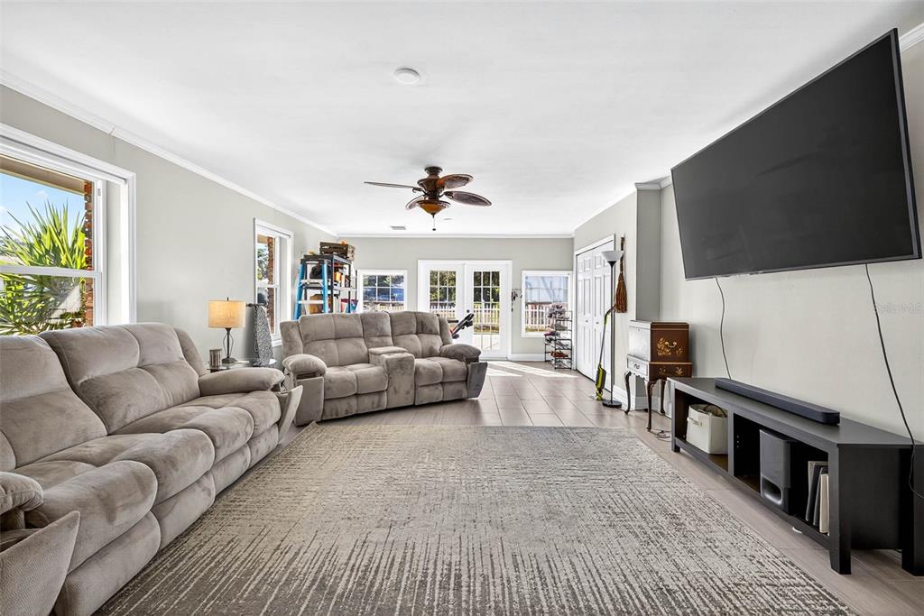 13589 101st Terrace Seminole, FL 33776 - Photo 20 of 43 a living room with furniture and a flat screen tv