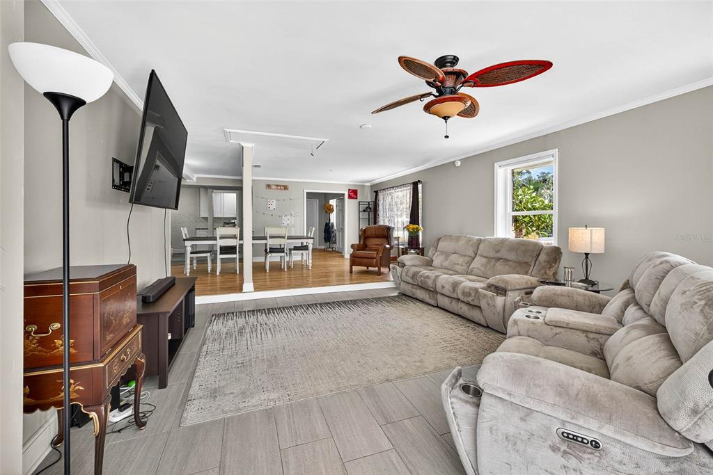 13589 101st Terrace Seminole, FL 33776 - Photo 21 of 43 a living room with furniture ceiling fan and a window