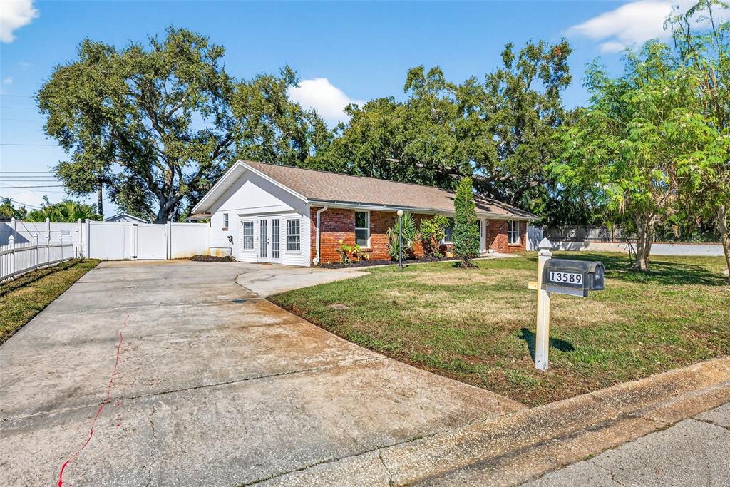 13589 101st Terrace Seminole, FL 33776 - Photo 4 of 43 a front view of a house with a yard