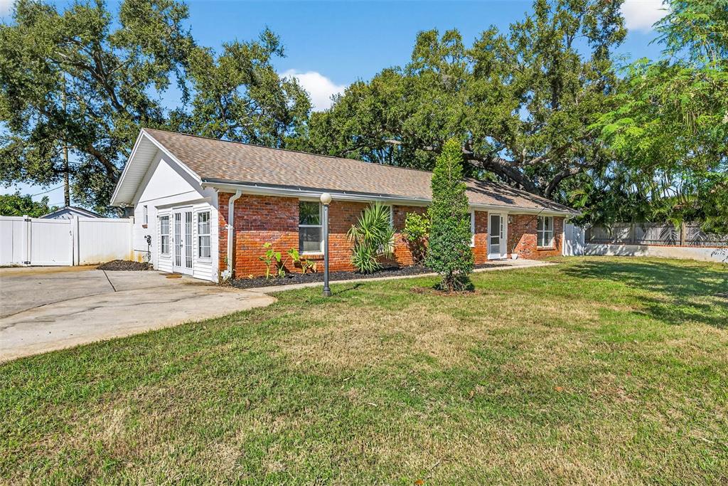 13589 101st Terrace Seminole, FL 33776 - Photo 5 of 43 a front view of house with yard and green space