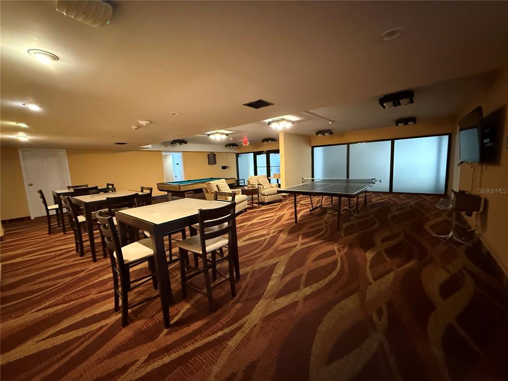 4141 Bayshore Boulevard, Unit 1203 Tampa, FL 33611 - Photo 13 of 16 a living room with a table a table and chairs