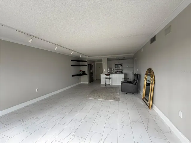 a view of a livingroom with wooden floor and windows