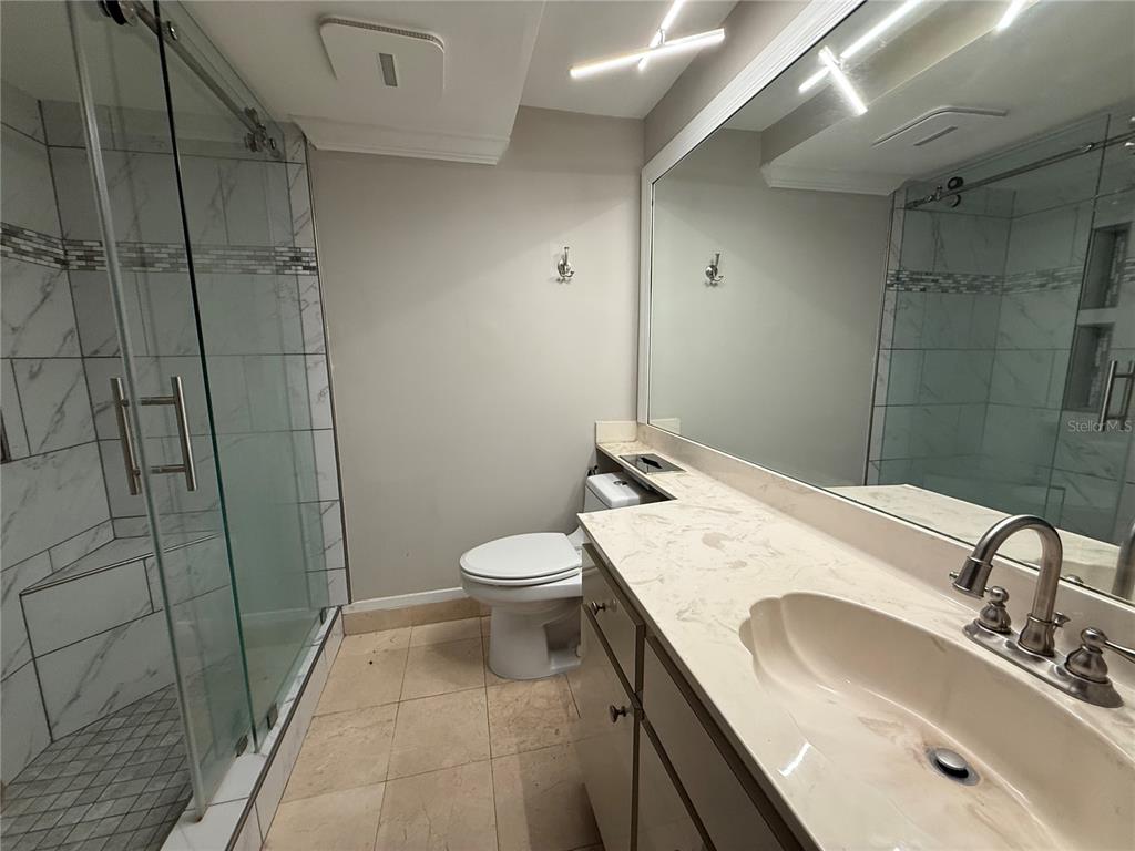 4141 Bayshore Boulevard, Unit 1203 Tampa, FL 33611 - Photo 6 of 16 a bathroom with a sink a toilet and shower