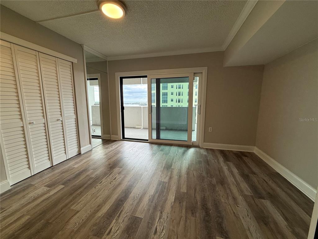 4141 Bayshore Boulevard, Unit 1203 Tampa, FL 33611 - Photo 7 of 16 wooden floor in an empty room with a window