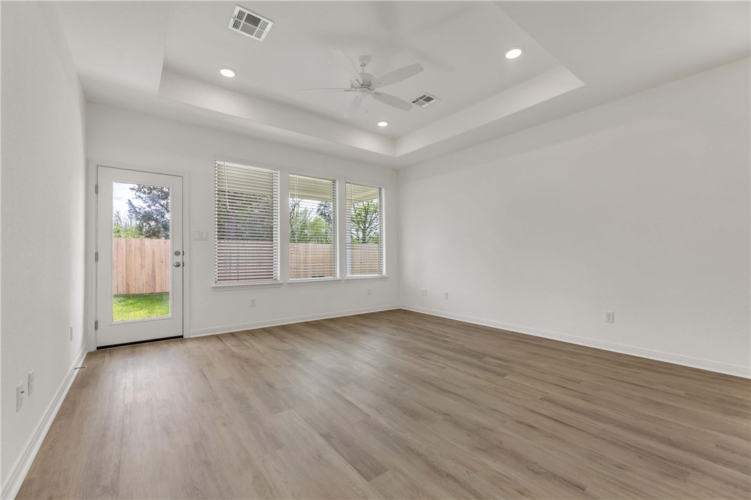 2776 Messenger Way Bryan, TX 77803 - Photo 9 of 16 an empty room with wooden floor and windows