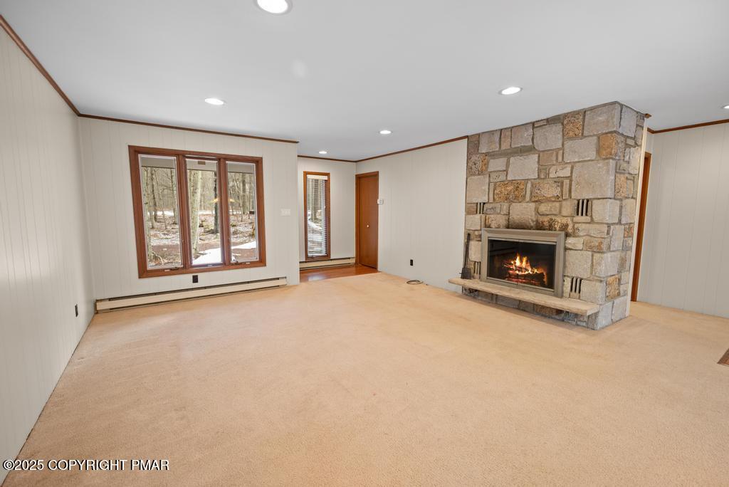 an empty room with a fireplace and window