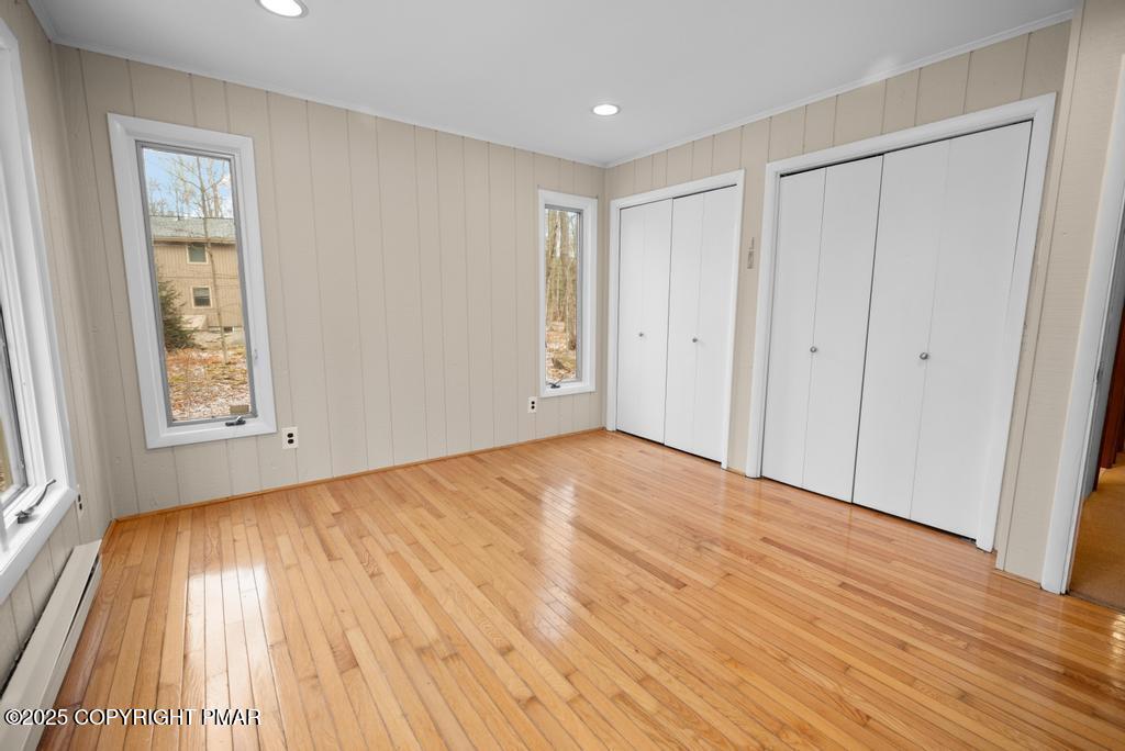 117 Outpost Way Pocono Pines, PA 18350 - Photo 17 of 36 a view of an empty room with wooden floor and a window