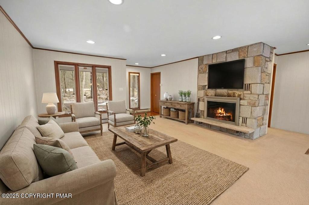 117 Outpost Way Pocono Pines, PA 18350 - Photo 2 of 36 a living room with furniture a flat screen tv and a fireplace