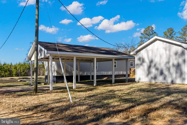 a view of a wooden house with a wooden deck