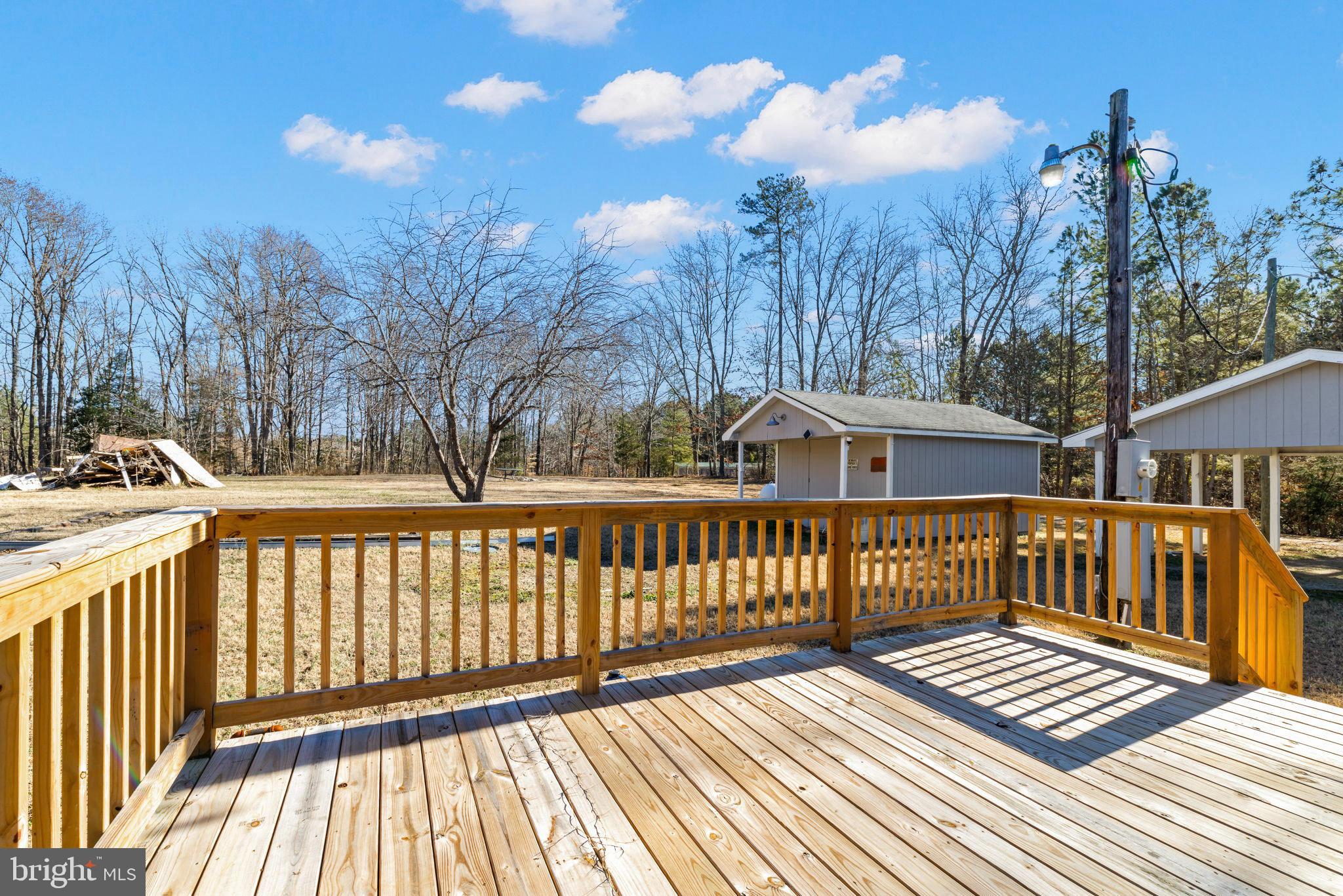 870 South Hill Road Brodnax, VA 23920 - Photo 12 of 39 a view of a wooden house with a wooden deck