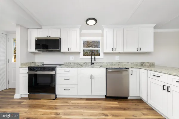 a view of a kitchen with a refrigerator and cabinets