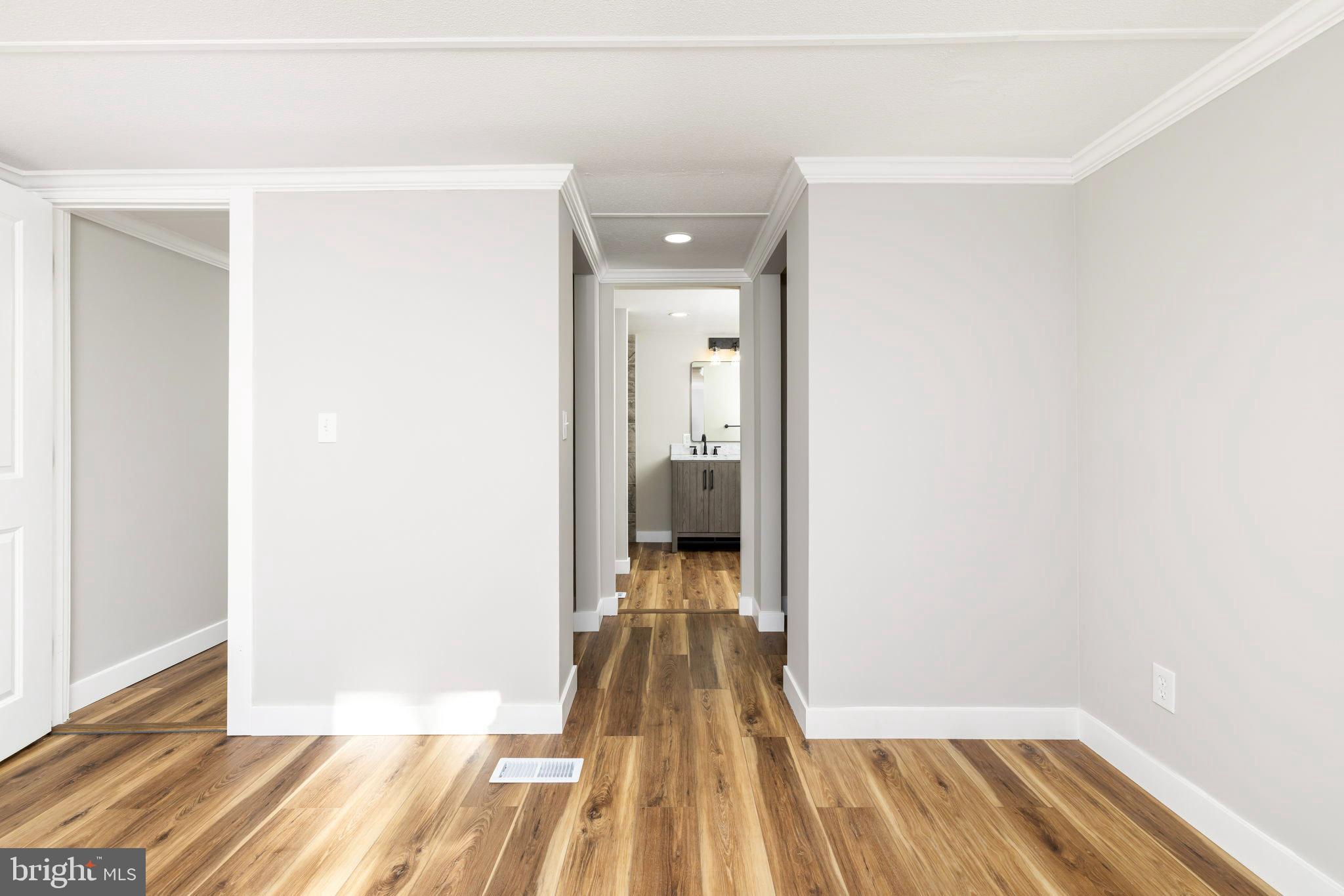 870 South Hill Road Brodnax, VA 23920 - Photo 21 of 39 a view of a room with wooden floor and a bathroom