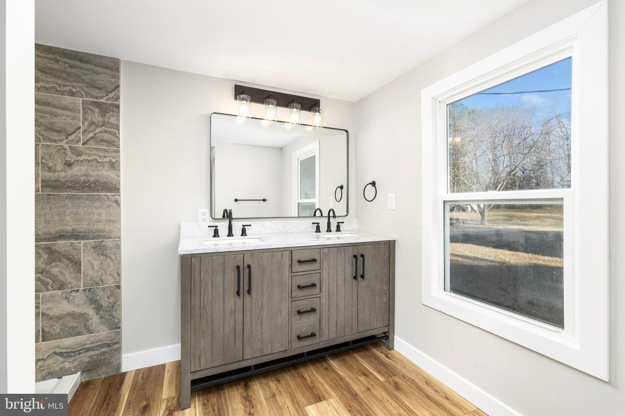 870 South Hill Road Brodnax, VA 23920 - Photo 28 of 39 a bathroom with a double vanity sink and mirror
