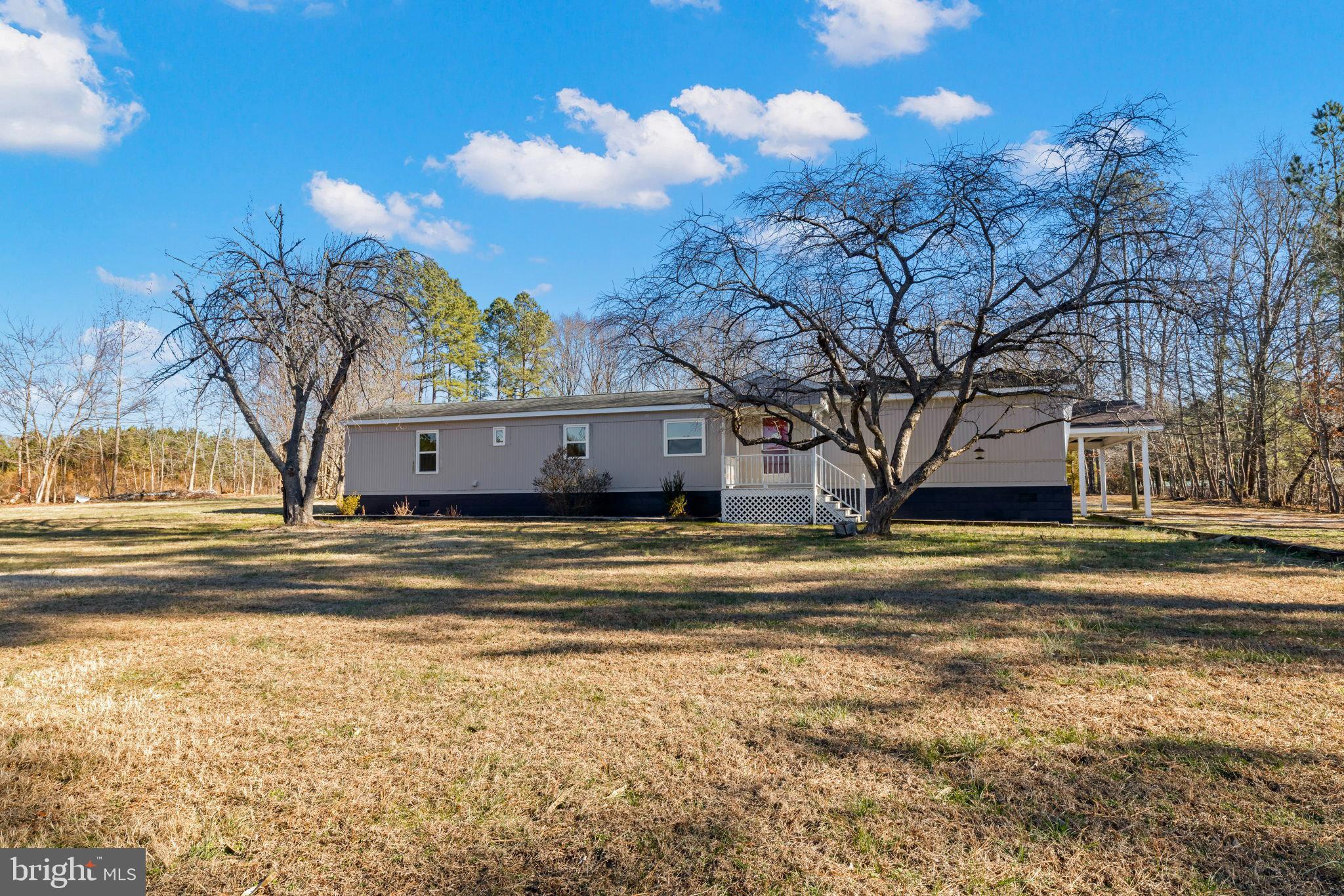 870 South Hill Road Brodnax, VA 23920 - Photo 3 of 39 a view of a house with a yard next to a building