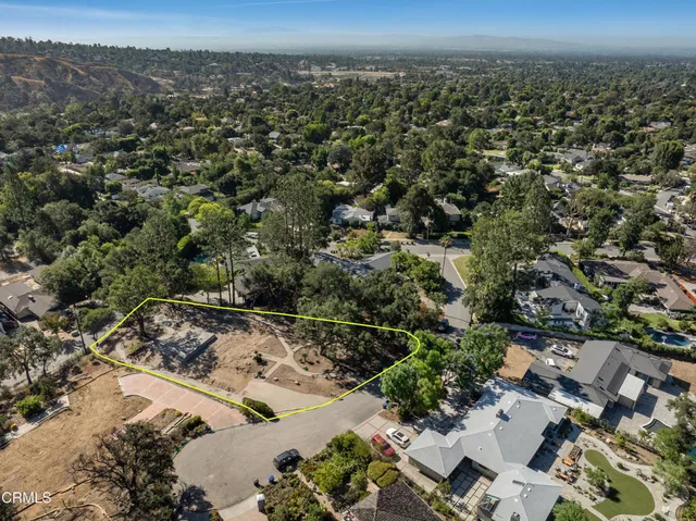 an aerial view of a houses with a yard