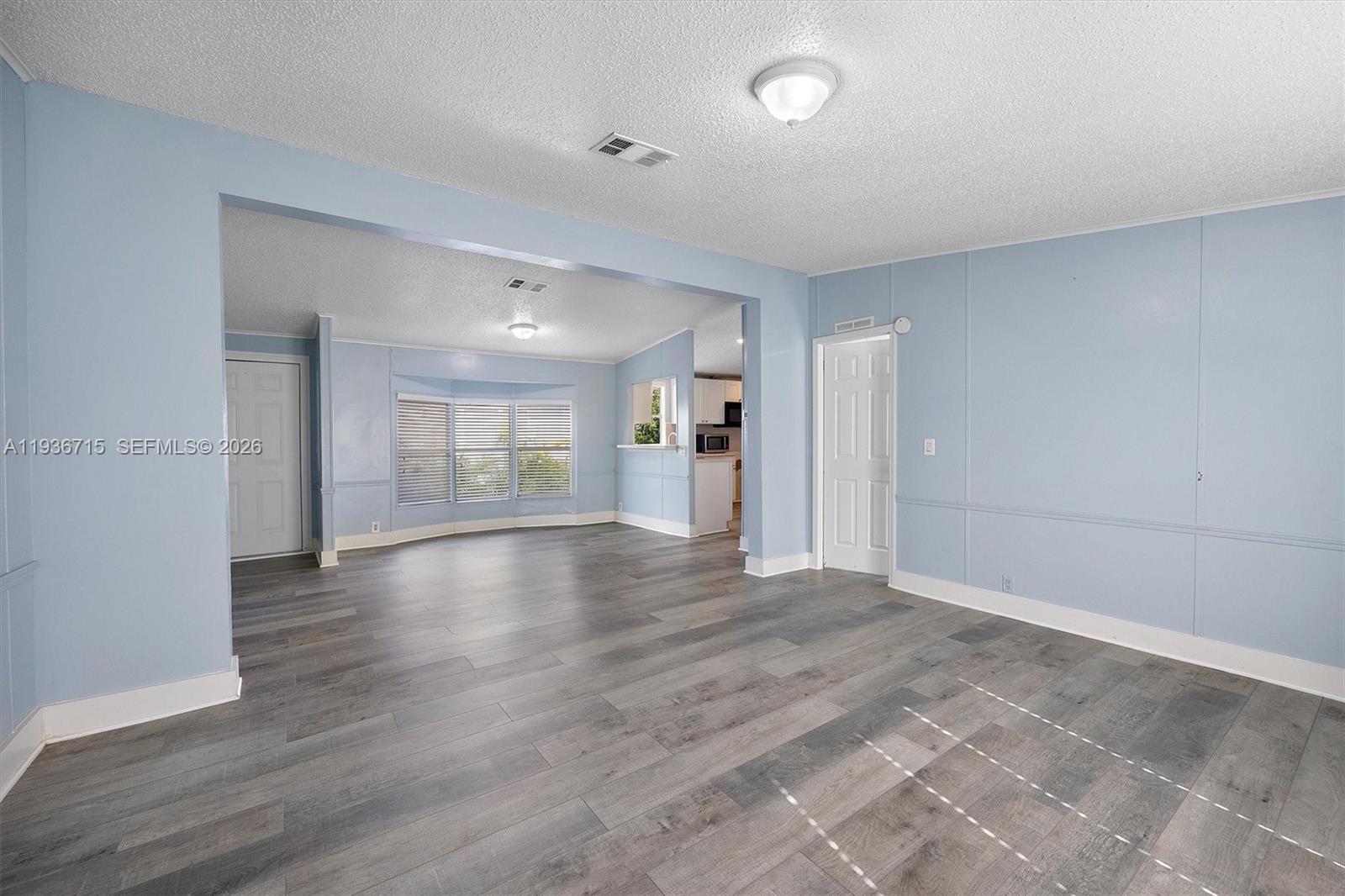 19800 Southwest 180th Avenue Miami, FL 33187 - Photo 12 of 36 a view of an empty room with wooden floor and a window