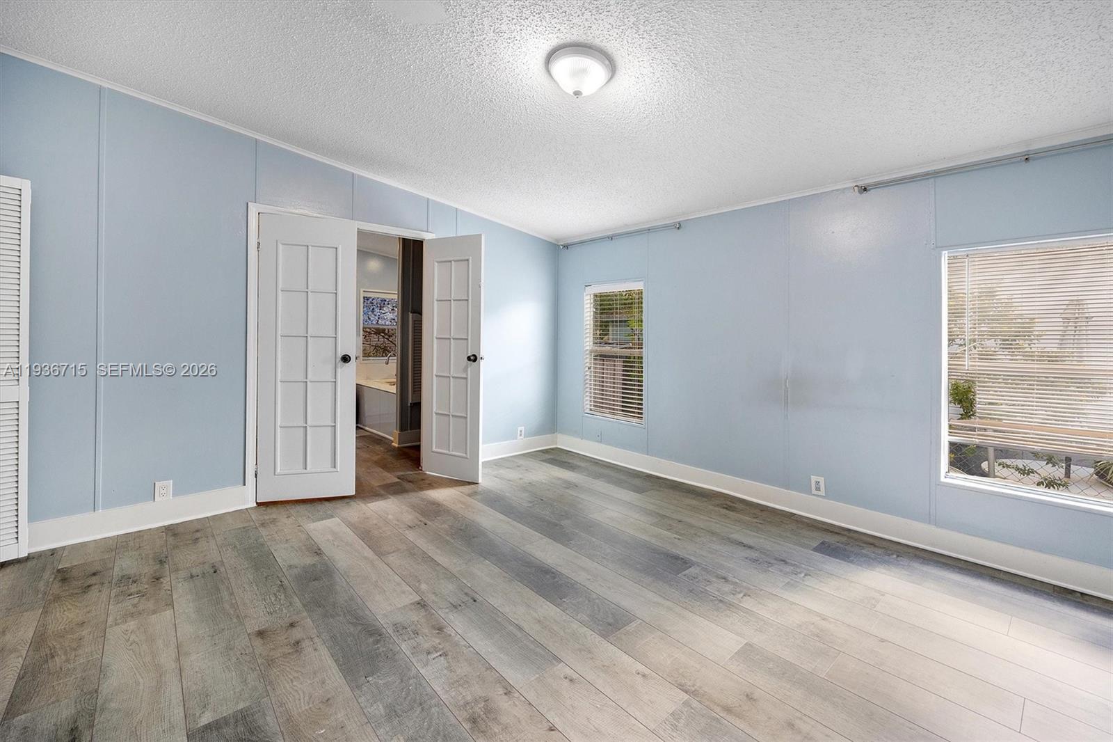 19800 Southwest 180th Avenue Miami, FL 33187 - Photo 13 of 36 an empty room with windows and closet