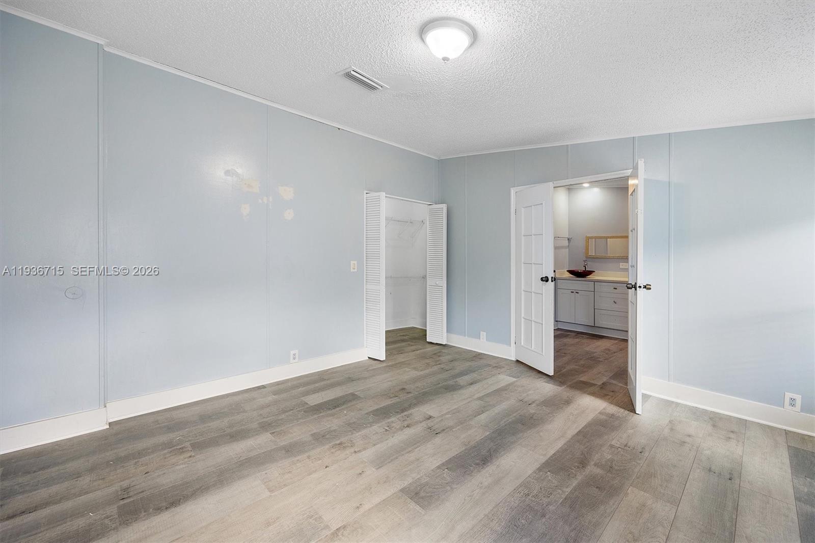 19800 Southwest 180th Avenue Miami, FL 33187 - Photo 14 of 36 wooden floor in an empty room with a bathroom