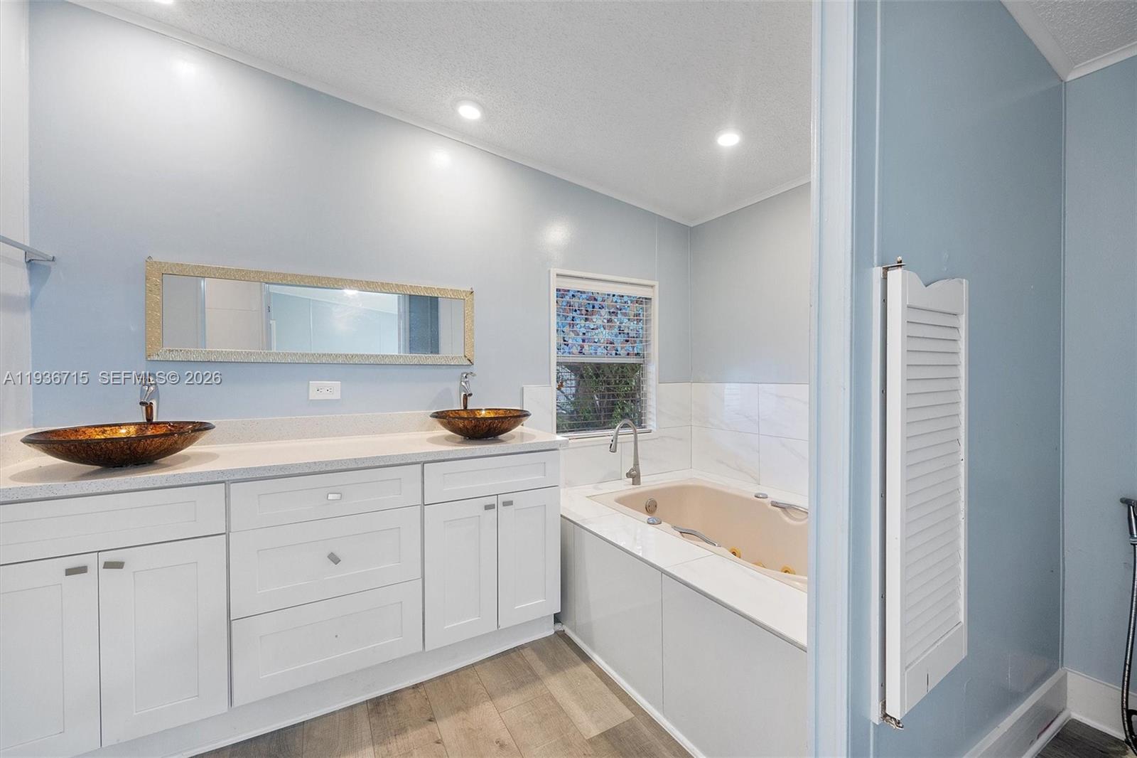 19800 Southwest 180th Avenue Miami, FL 33187 - Photo 16 of 36 a bathroom with a sink and a bathtub