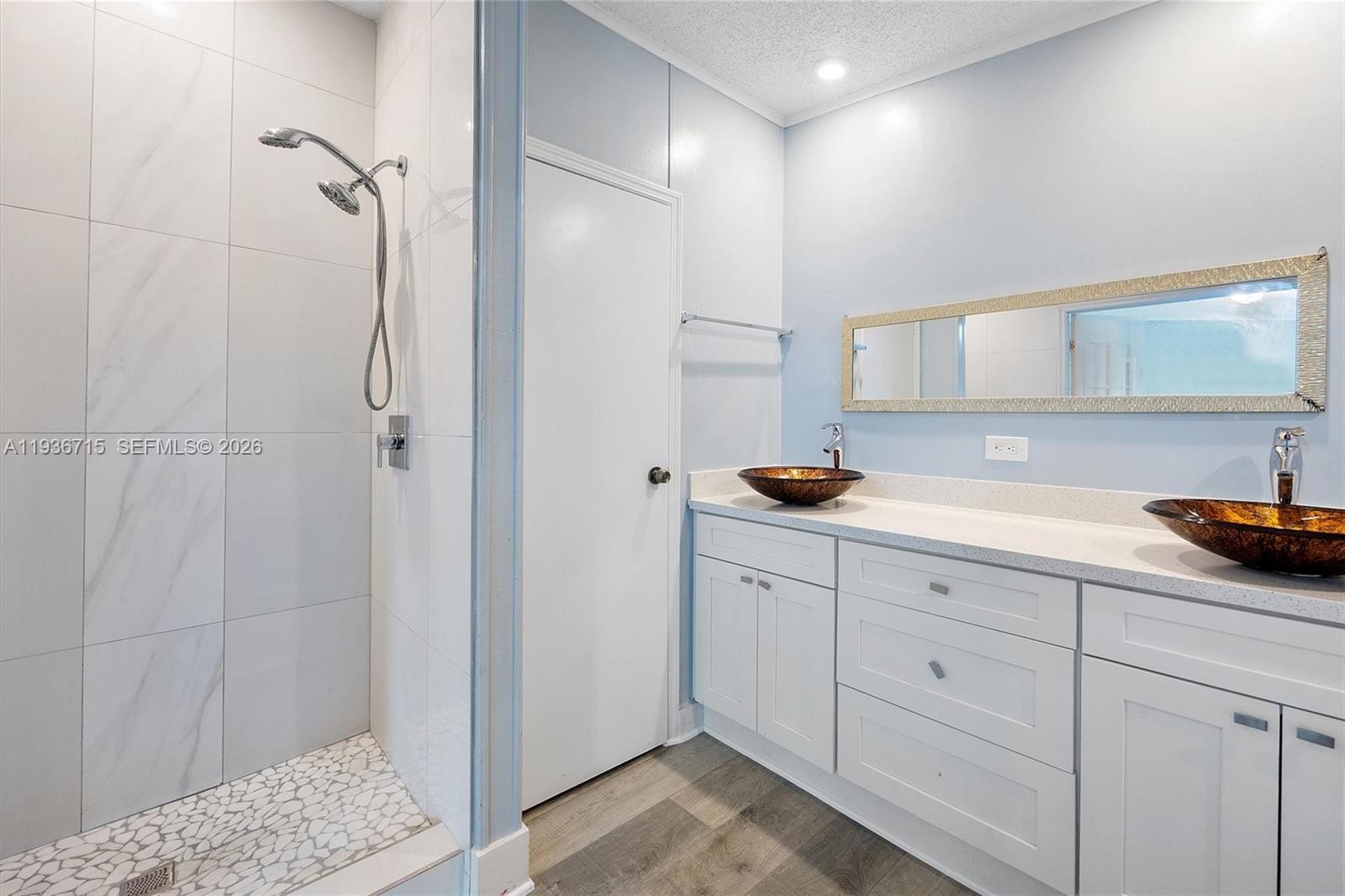 19800 Southwest 180th Avenue Miami, FL 33187 - Photo 17 of 36 a bathroom with a sink a mirror and a shower