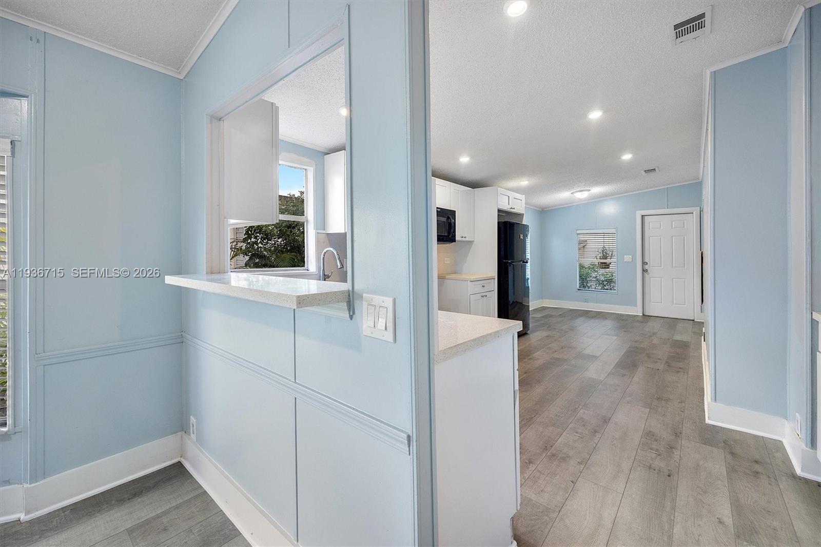 19800 Southwest 180th Avenue Miami, FL 33187 - Photo 18 of 36 a view of a hallway with wooden floor and a bathroom
