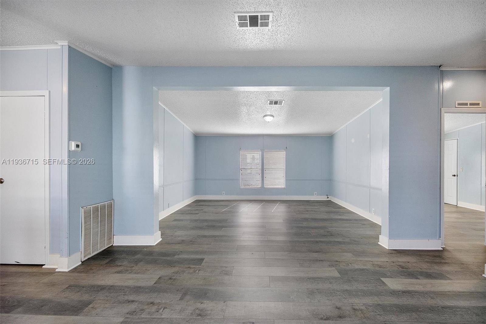 19800 Southwest 180th Avenue Miami, FL 33187 - Photo 2 of 36 an empty room with wooden floor and windows