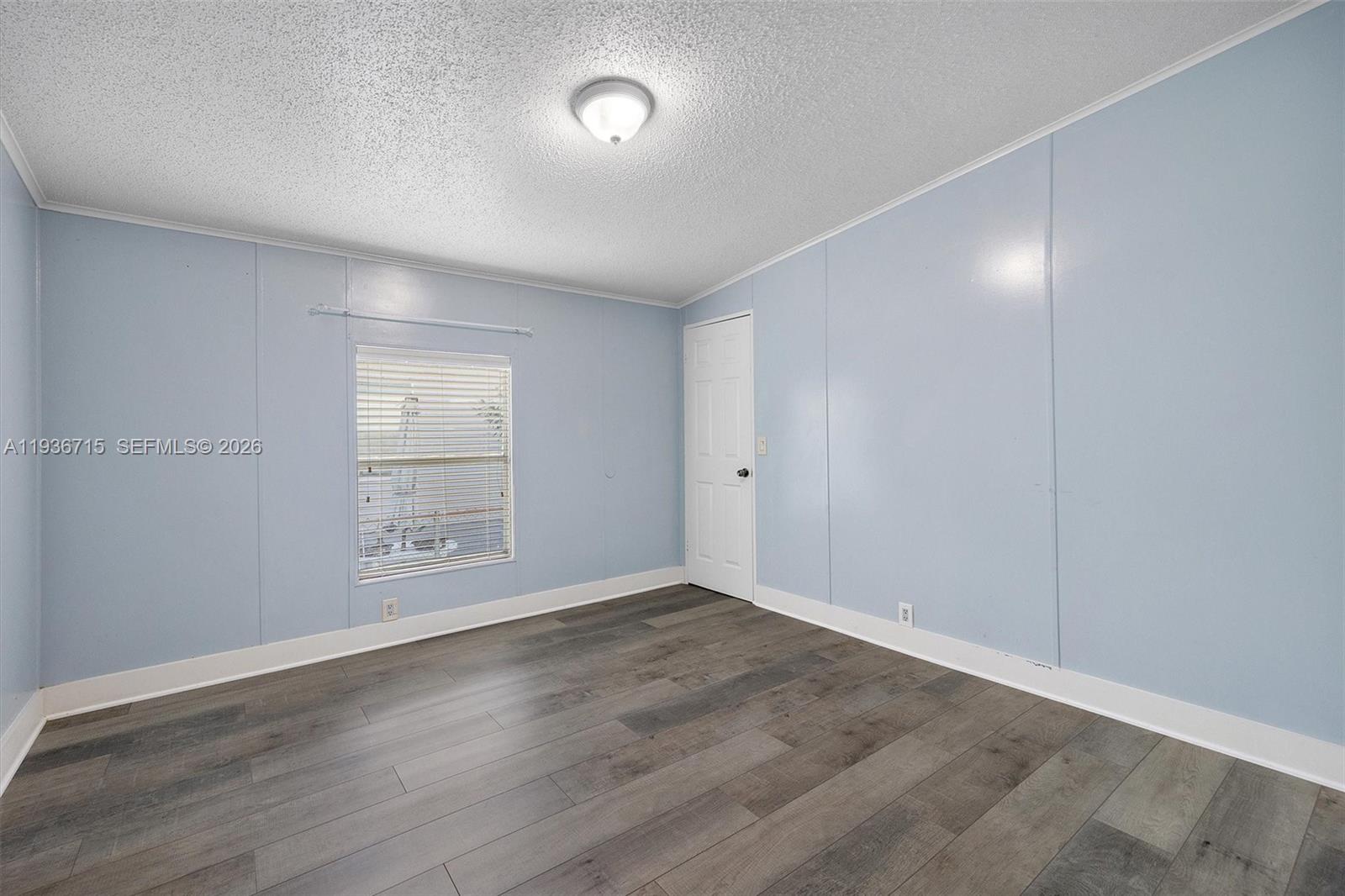 19800 Southwest 180th Avenue Miami, FL 33187 - Photo 23 of 36 an empty room with wooden floor and windows