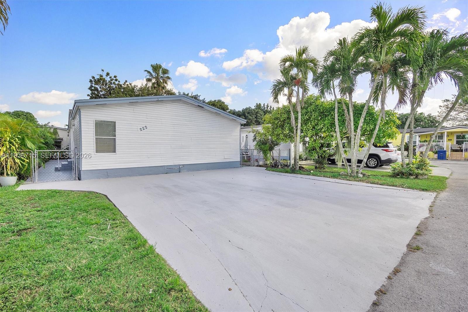 19800 Southwest 180th Avenue Miami, FL 33187 - Photo 33 of 36 a front view of a house with a yard and garage
