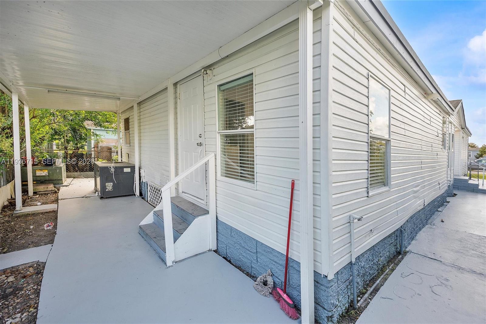 19800 Southwest 180th Avenue Miami, FL 33187 - Photo 35 of 36 a view of a balcony with couch and the view of the porch