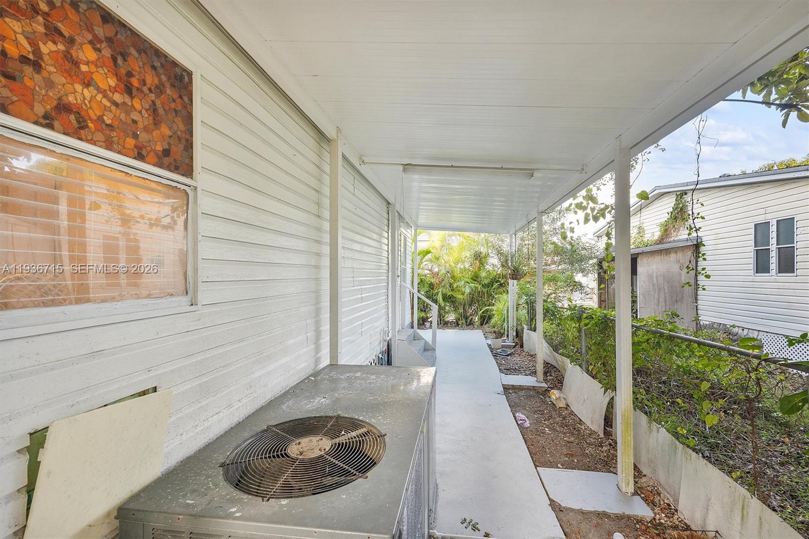 19800 Southwest 180th Avenue Miami, FL 33187 - Photo 36 of 36 a view of a porch with furniture and floor to ceiling window