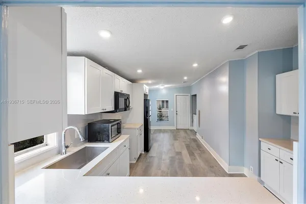 a kitchen with stainless steel appliances granite countertop a sink and a stove