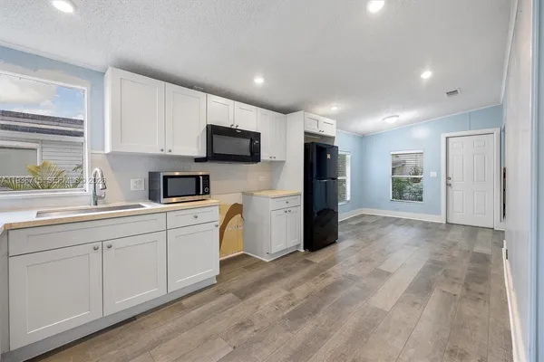 a kitchen with stainless steel appliances granite countertop a refrigerator sink and cabinets