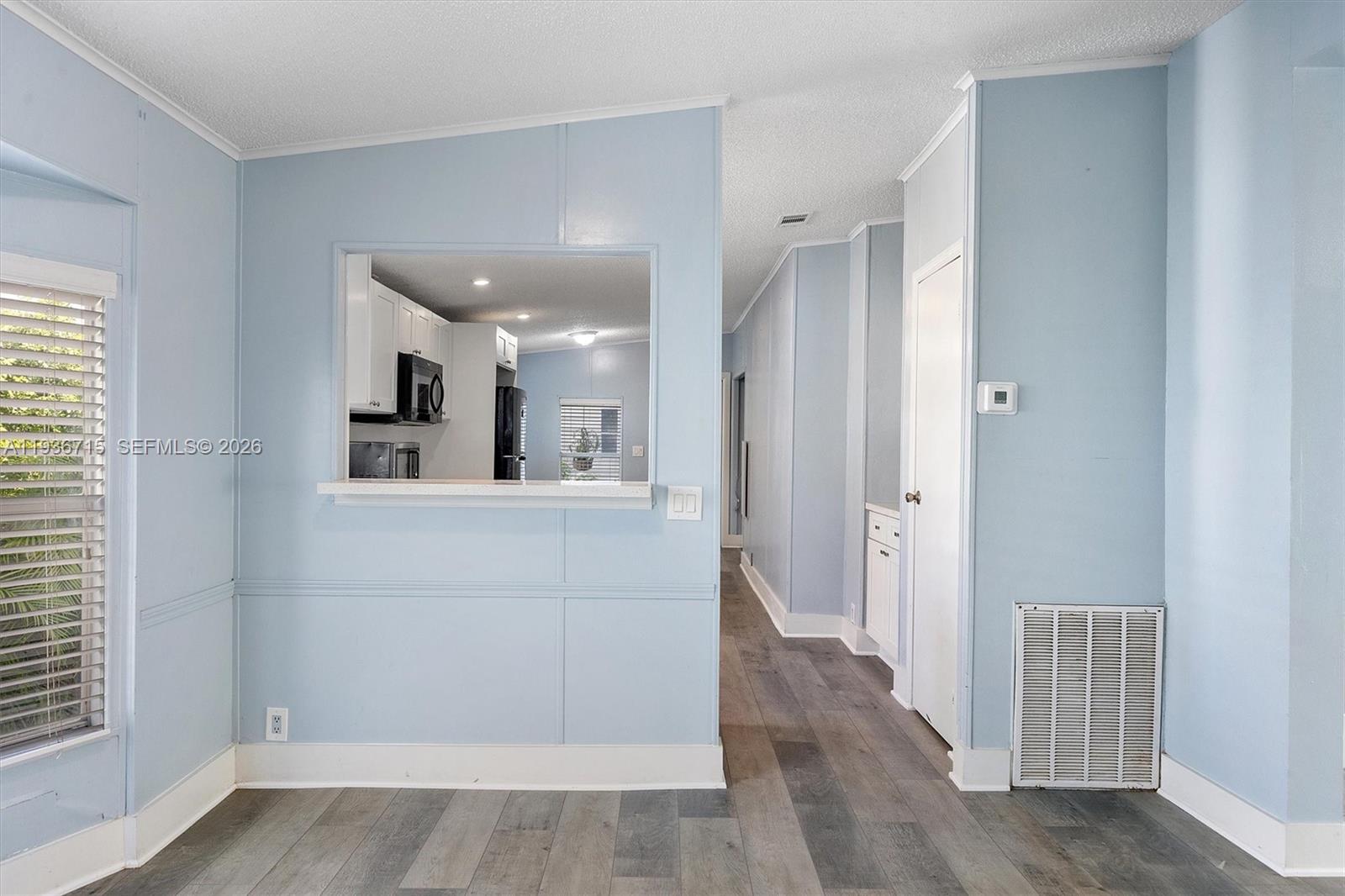19800 Southwest 180th Avenue Miami, FL 33187 - Photo 6 of 36 a view of a hallway with wooden floor and cabinet