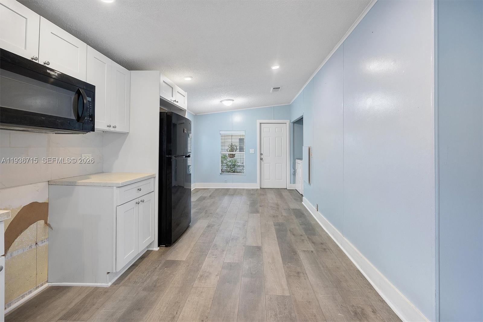19800 Southwest 180th Avenue Miami, FL 33187 - Photo 7 of 36 a view of a storage & utility room with flat screen tv