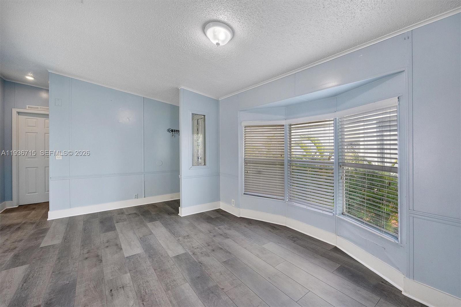 19800 Southwest 180th Avenue Miami, FL 33187 - Photo 8 of 36 an empty room with wooden floor and windows