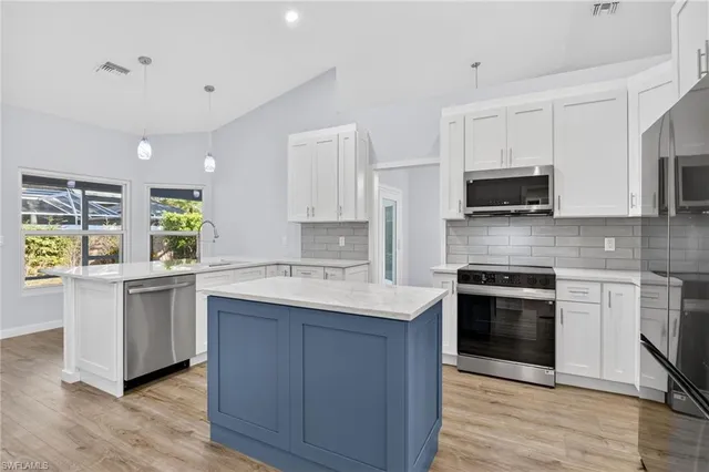 a kitchen with a sink a stove a refrigerator and a refrigerator