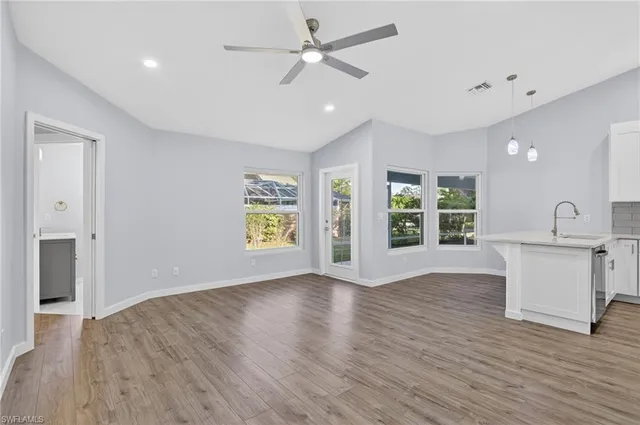 a view of kitchen with sink and wooden floor