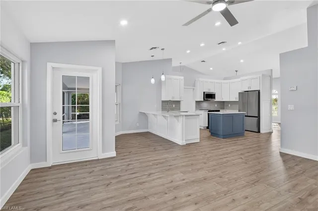 a kitchen with kitchen island a counter top and a stove