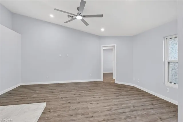 wooden floor in an empty room with a window