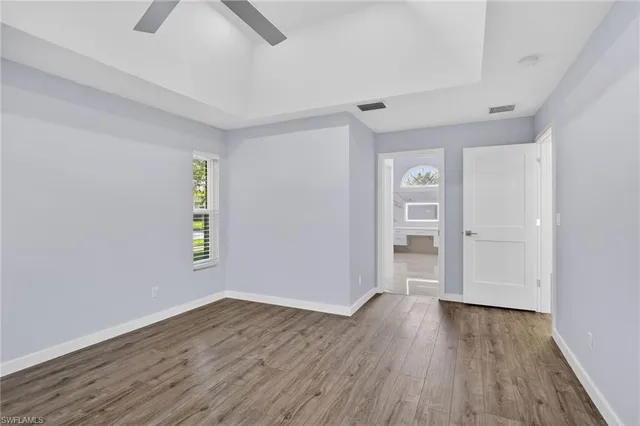 a bathroom with a granite countertop sink mirror and a bathtub